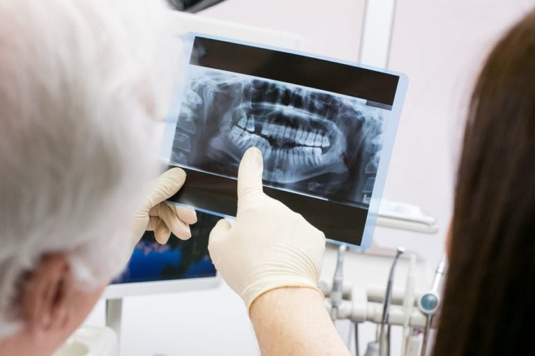 Image of dentist explaining the patient dental problem