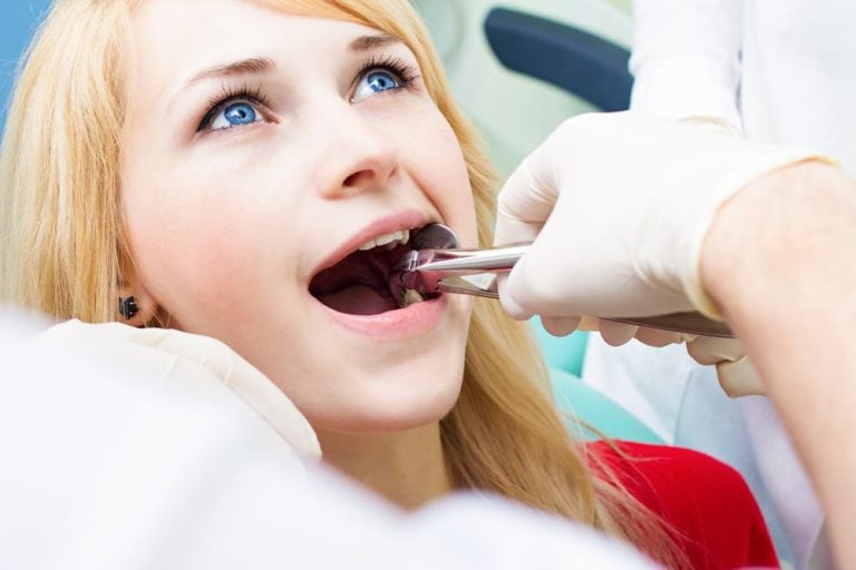 Image of female patient doctor checking teeth